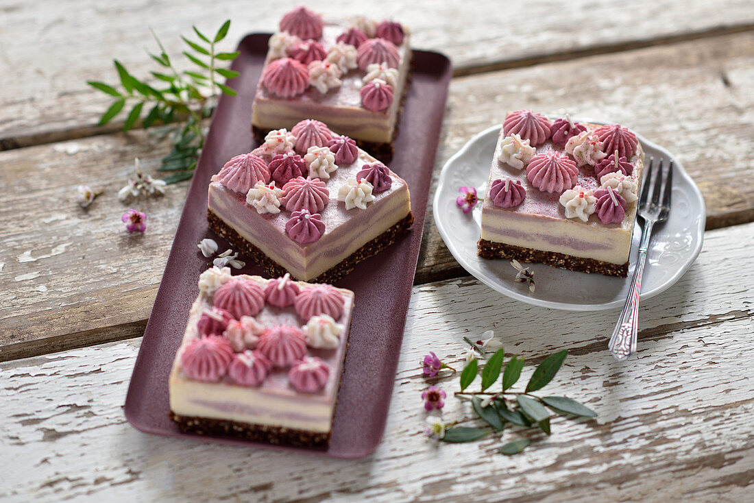 Vegan no-bake vanilla and raspberry cheesecake with chocolate topping and cream tuffs