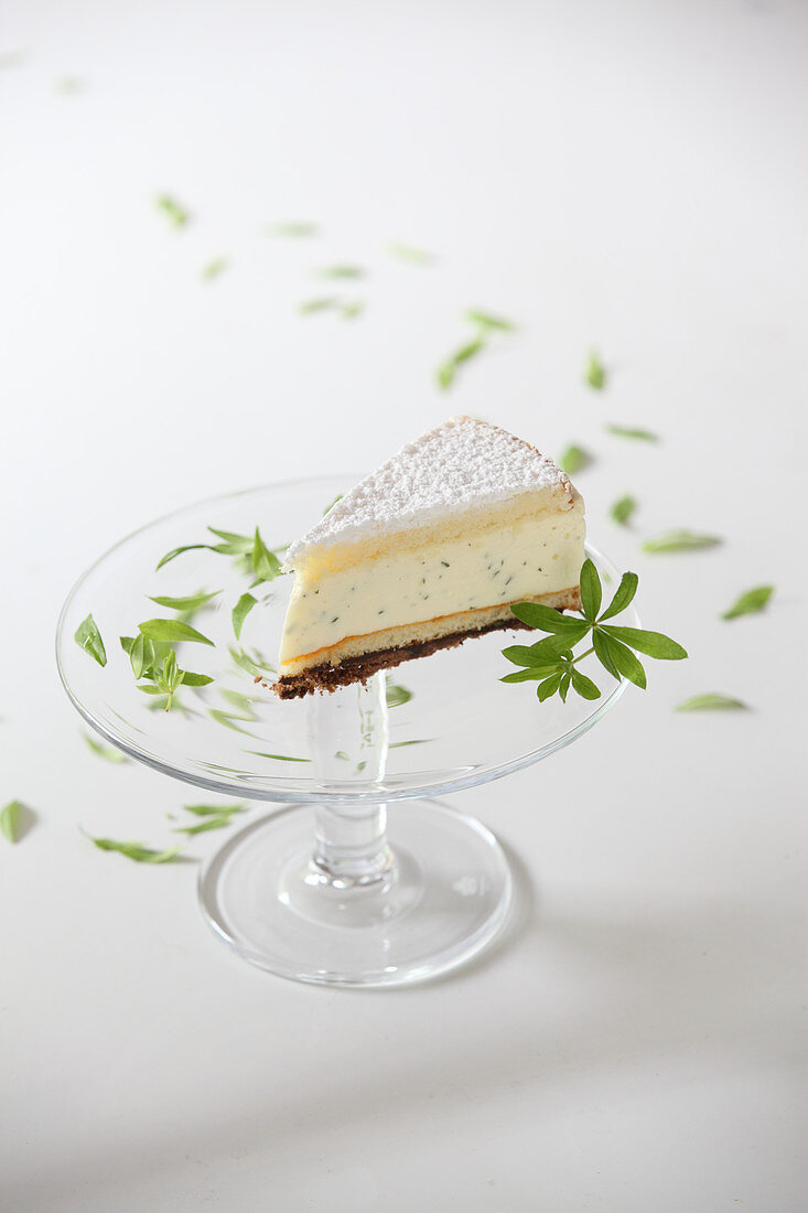 A piece of woodruff cake on a cake stand