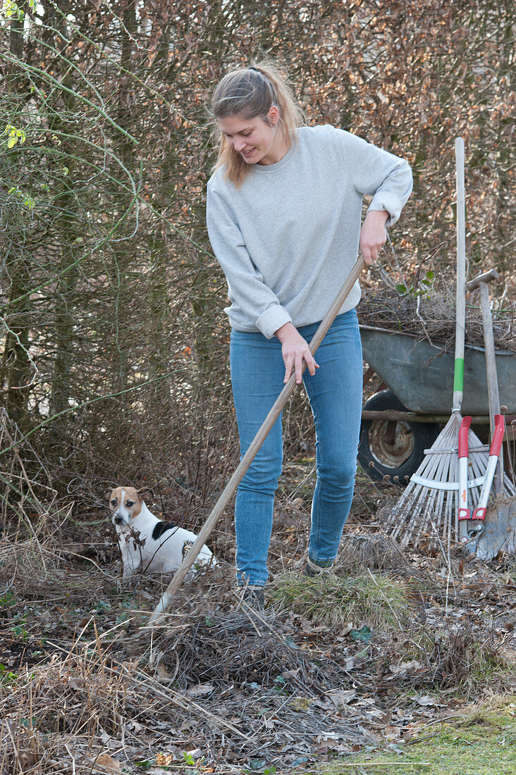 Woman doing spring cleaning in the garden