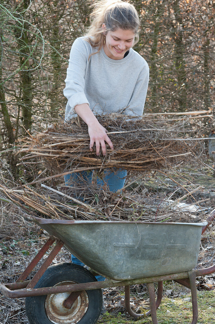 Woman doing spring cleaning in the garden