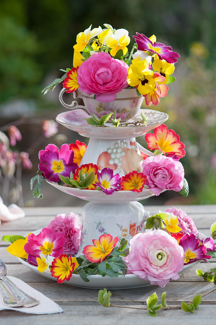 Homemade cake stands made from cups and plates with colourful spring flowers