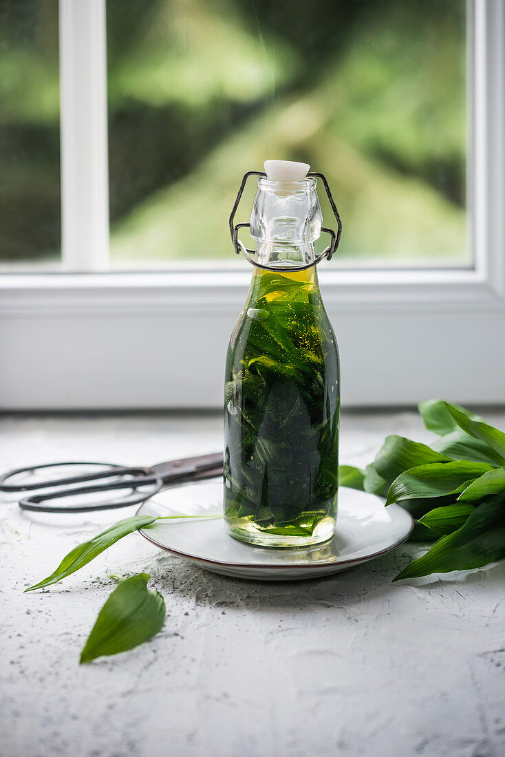 Wild garlic oil in a glass bottle