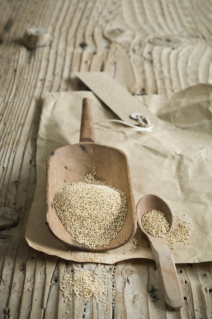 Organic amaranth on a wooden scoop on a rustic wooden table
