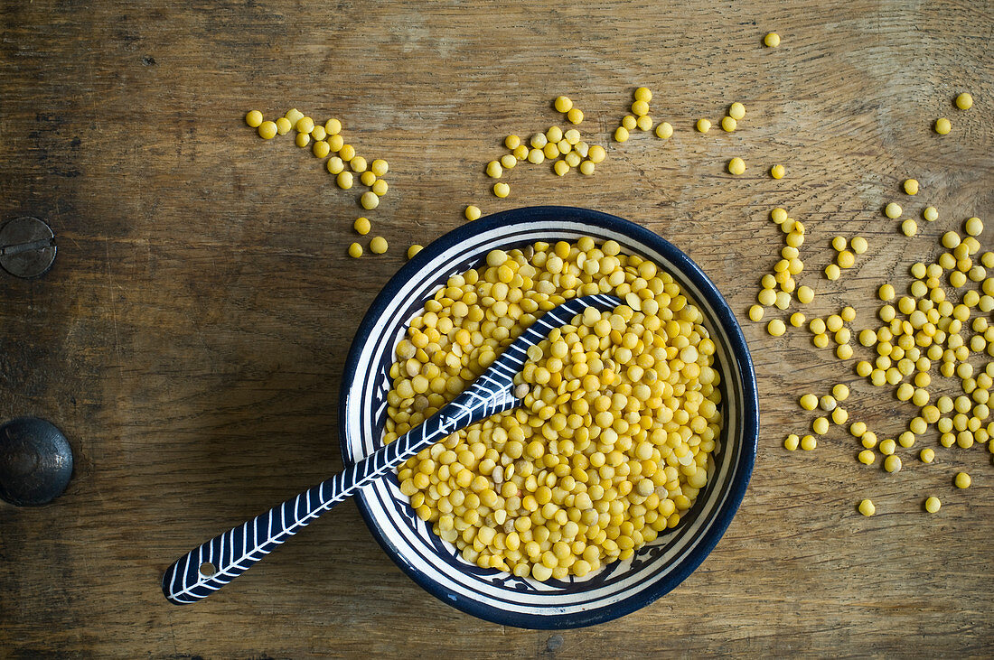 Yellow lentils in a bowl with a spoon