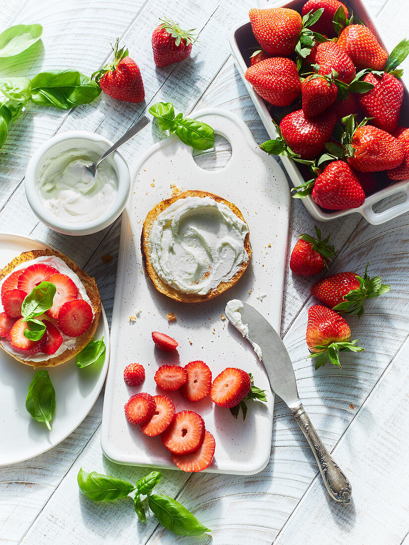 A roll spread with cream cheese and strawberries