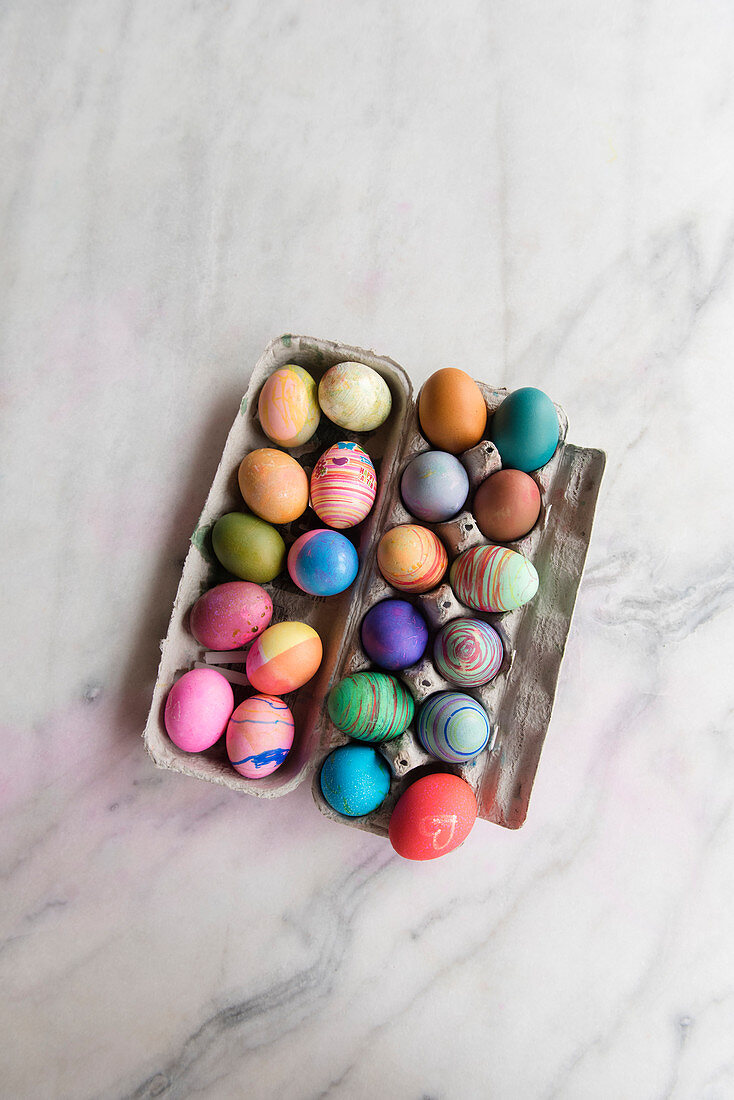 Dyed eggs in carton