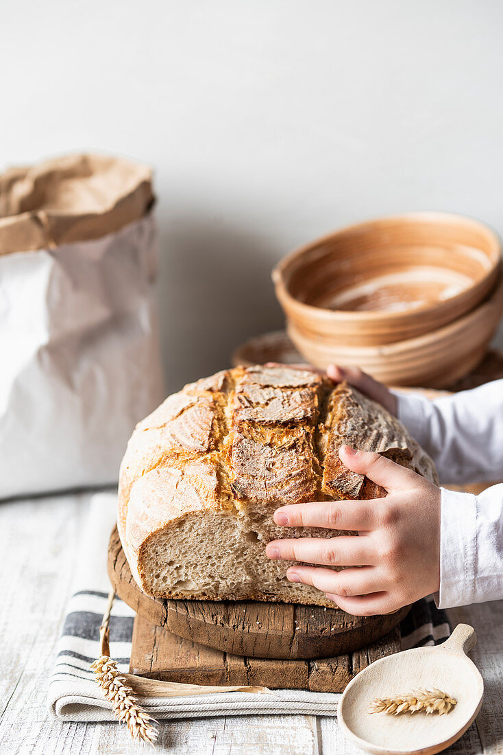 Sliced sour dough bread being placed on a chopping board