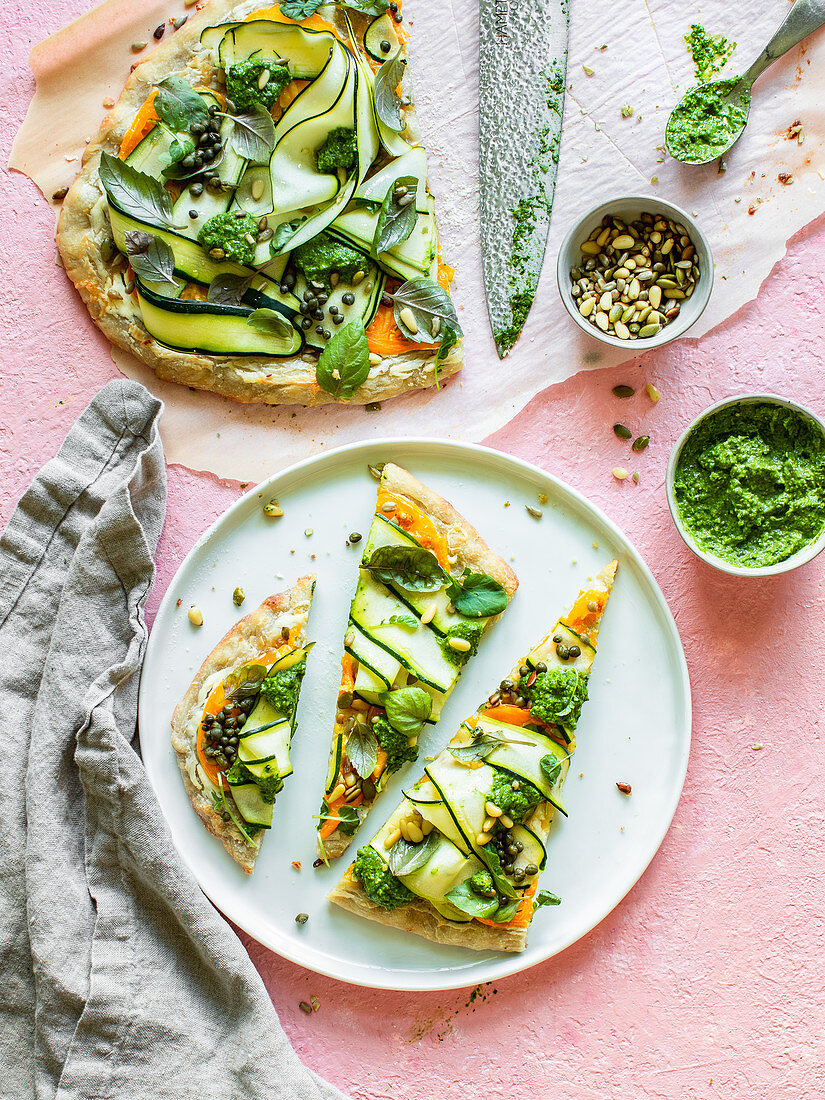 A pizza with courgette, herbs and pesto