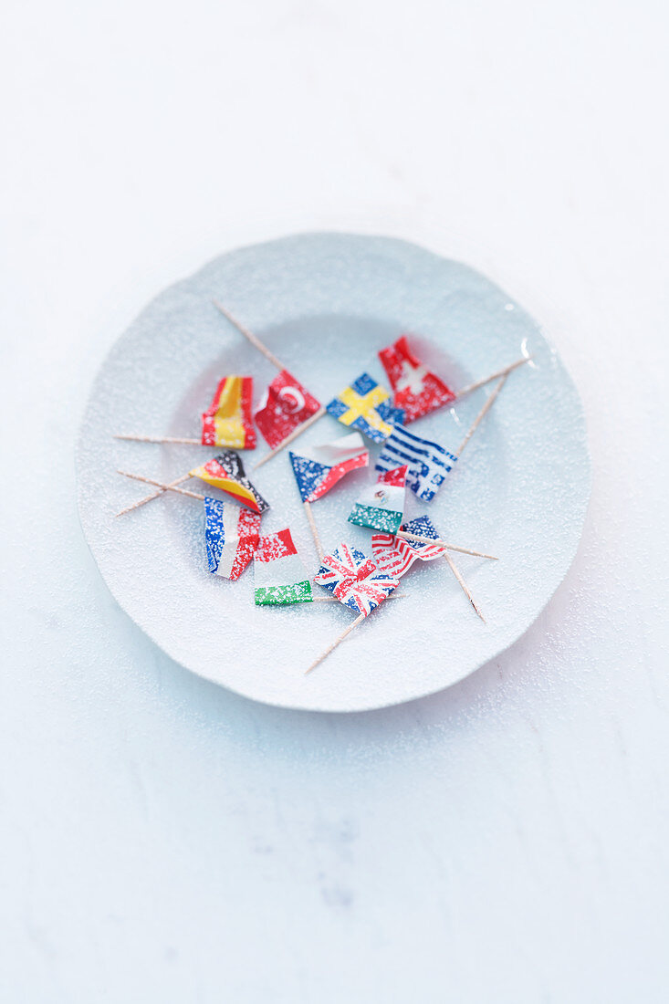 Small paper flags on a white plate