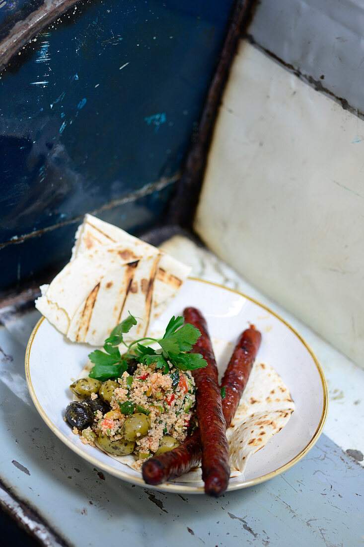 Merguez with couscous salad and unleavened bread