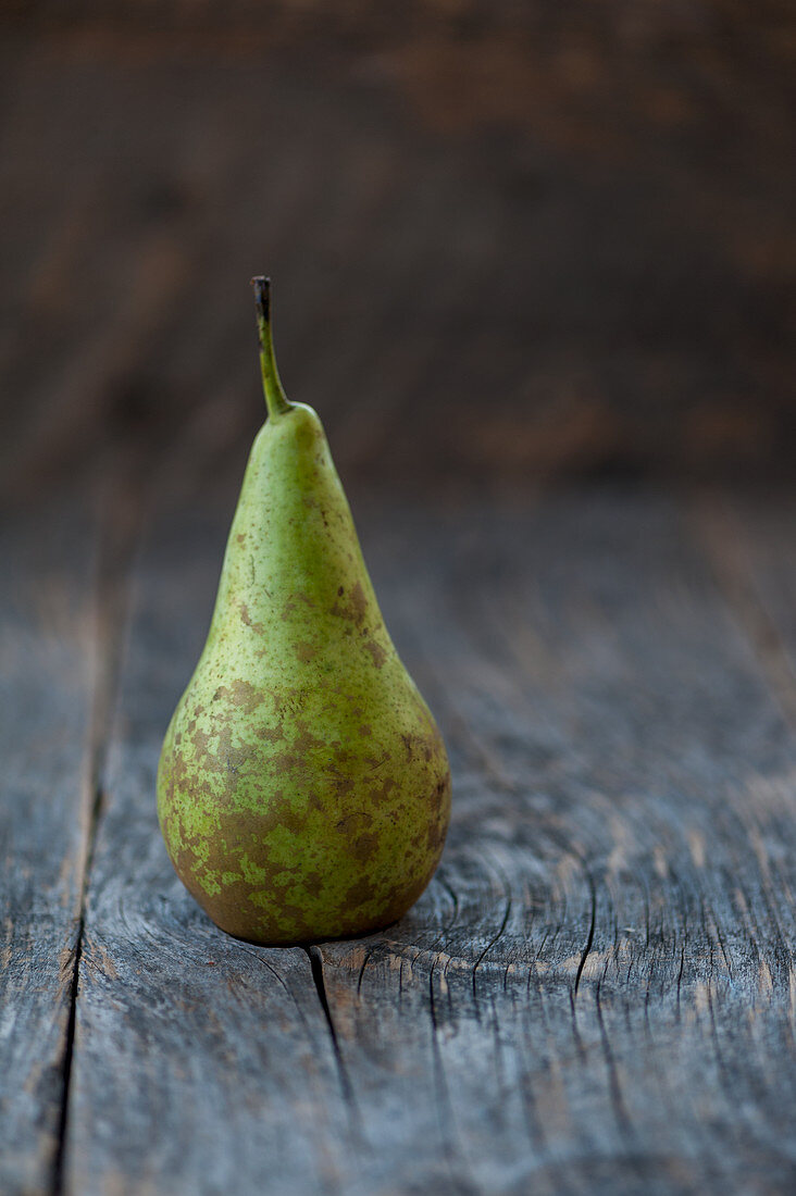 A Williams pear on a rustic background