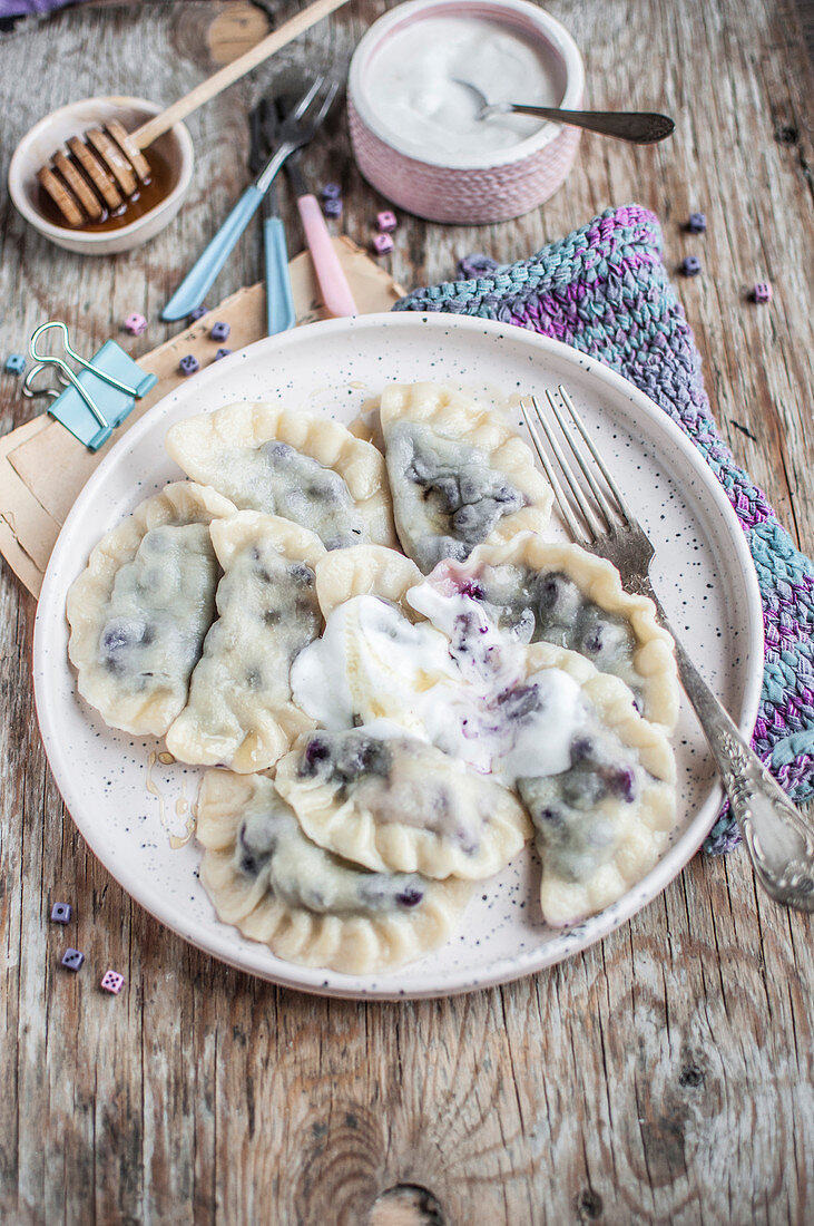 Blueberry dumplings served with yoghurt and honey