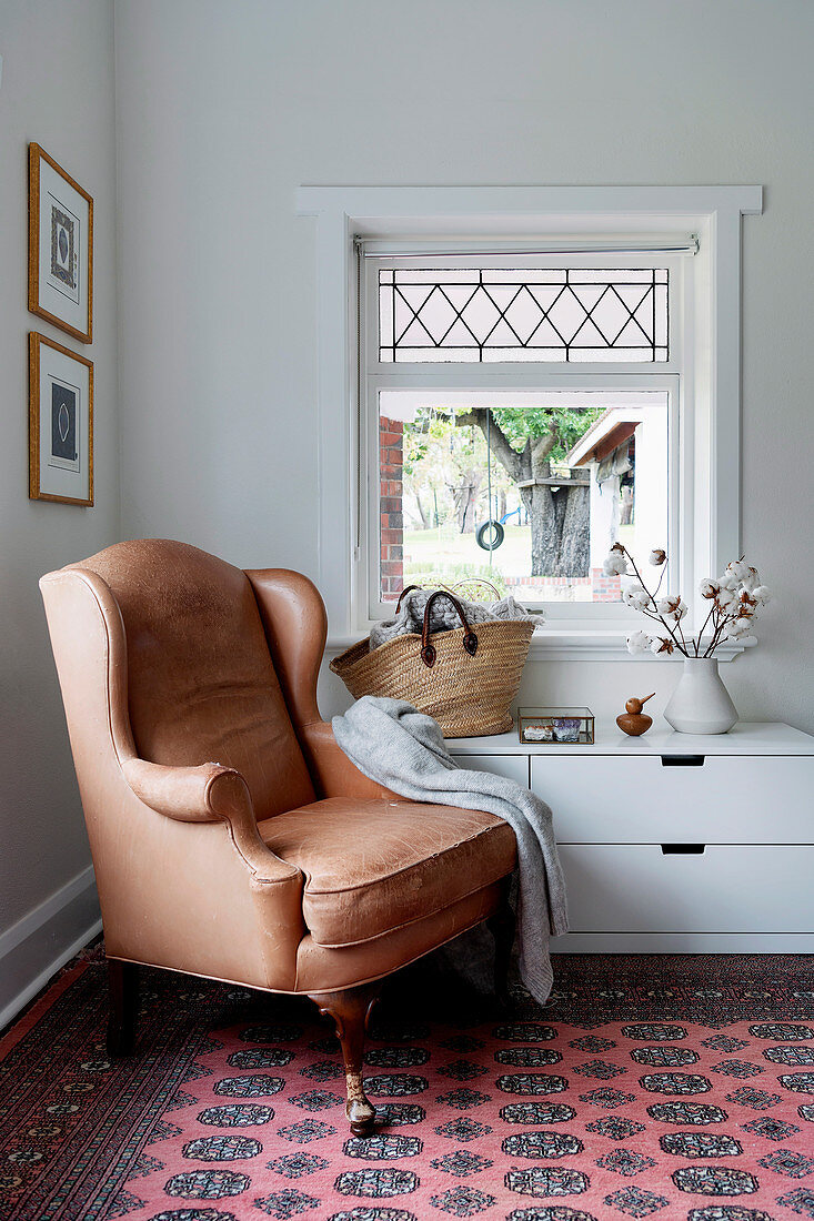 Antique leather armchair in corner of room