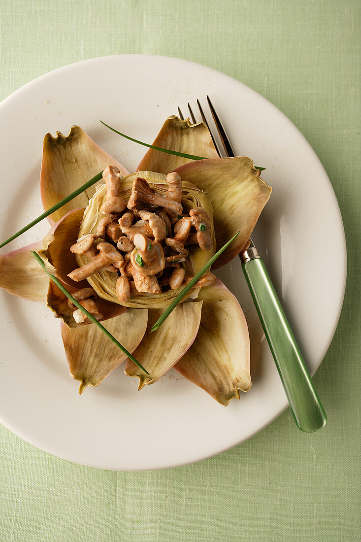 An artichoke stuffed with chanterelle mushroom ragout