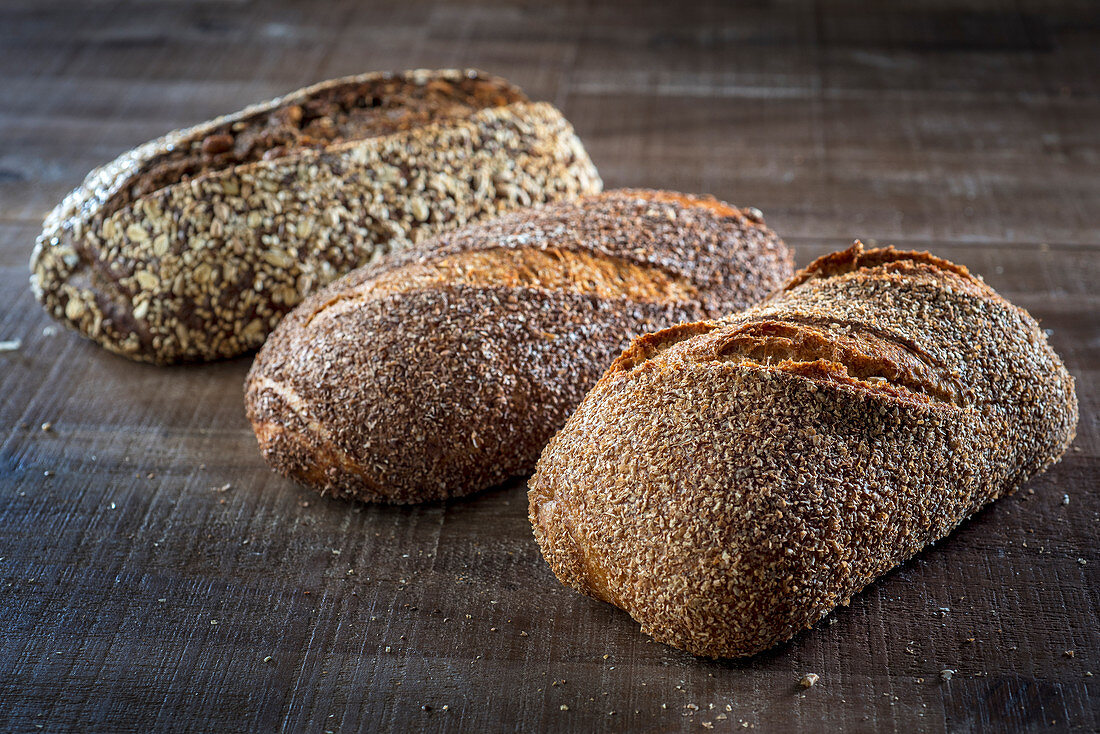 Three different loaves of seeded bread