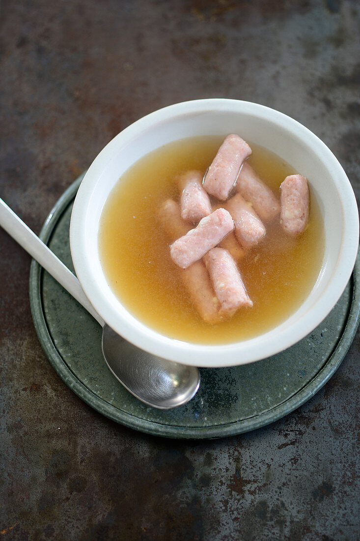 Mini Käsekrainer (cheese filled sausages) in a clear beef broth