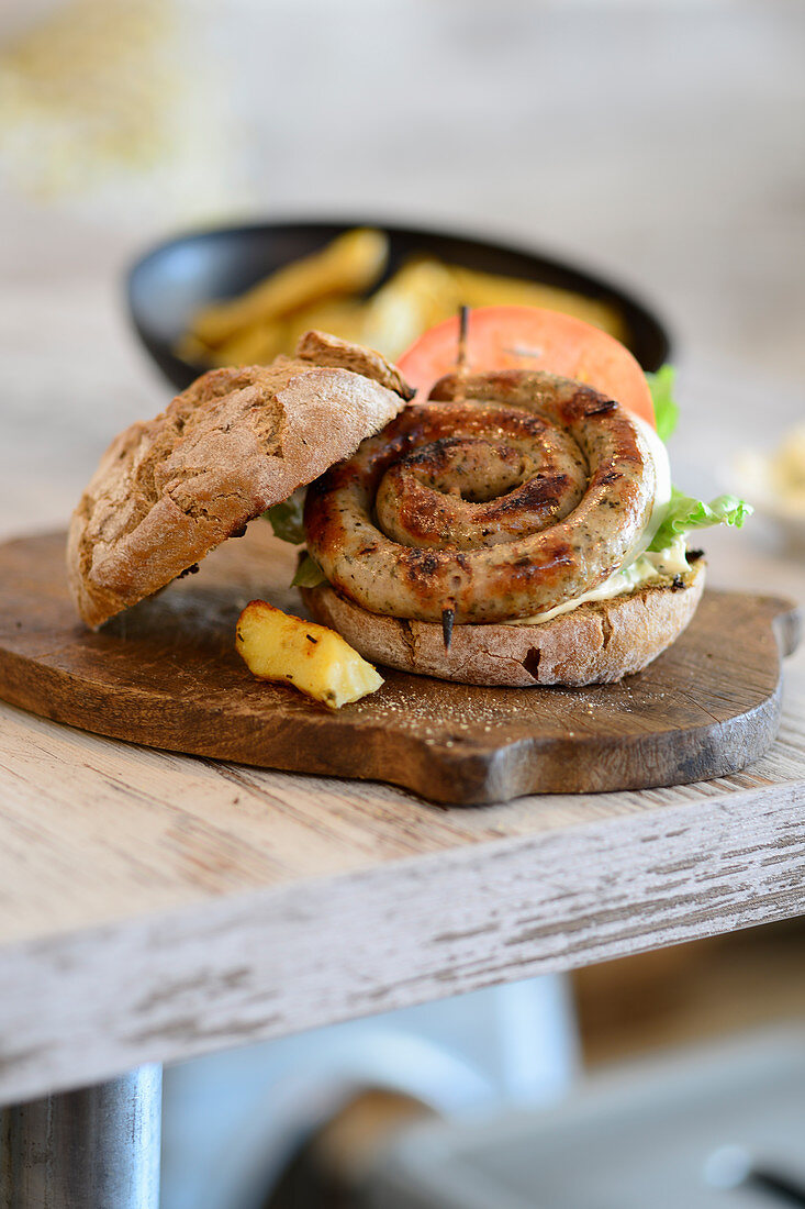 A spiral sausage burger and potato wedges