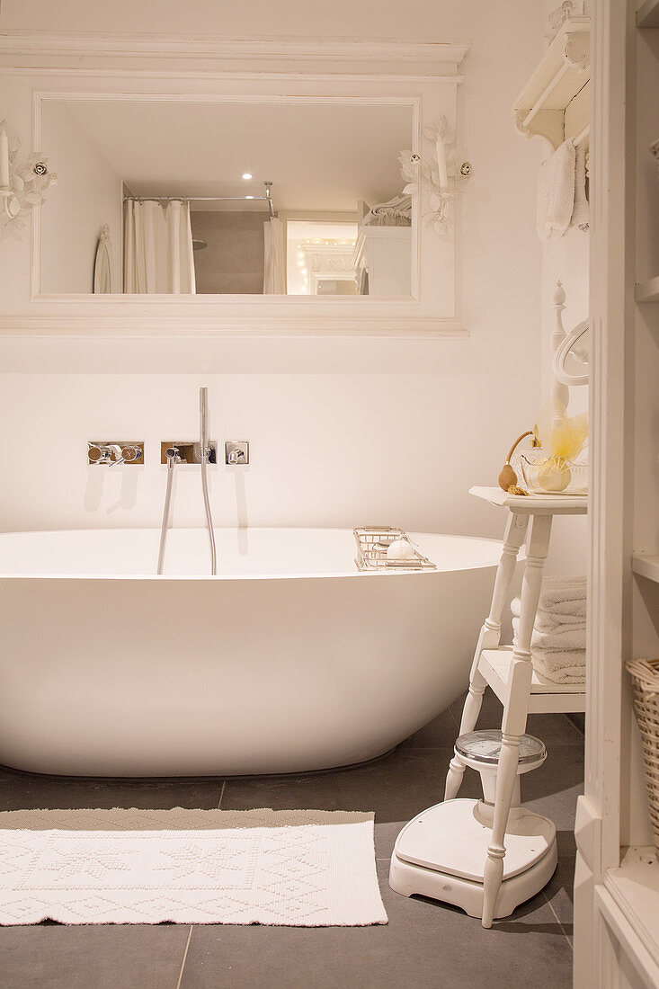 Modern oval bathtub in white, vintage-style bathroom