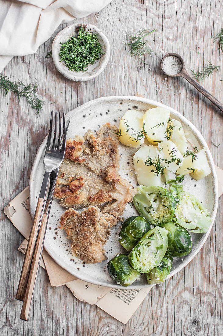 Oyster mushroom schintzel served with potatoes, brussels sprout and fresh dill