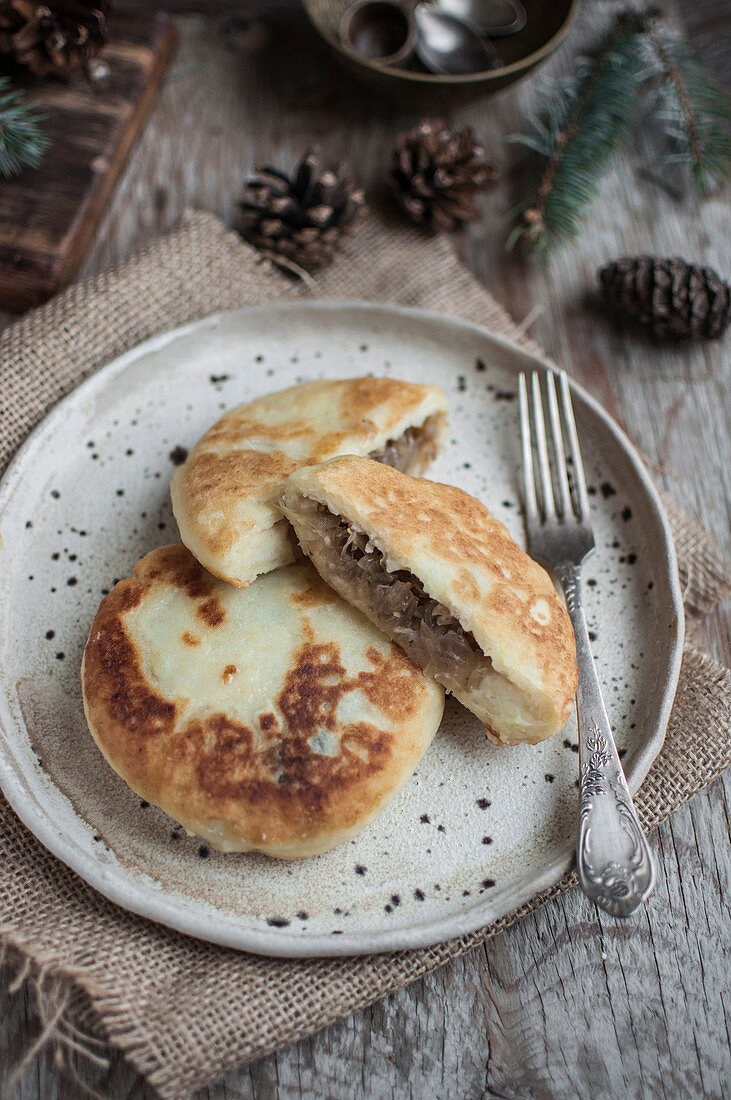 Potato cakes filled with cabbage and mushrooms (farszynki)