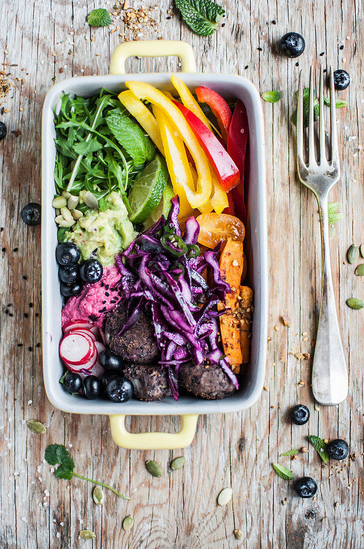 Rainbow vegan buddha bowl with black bean balls