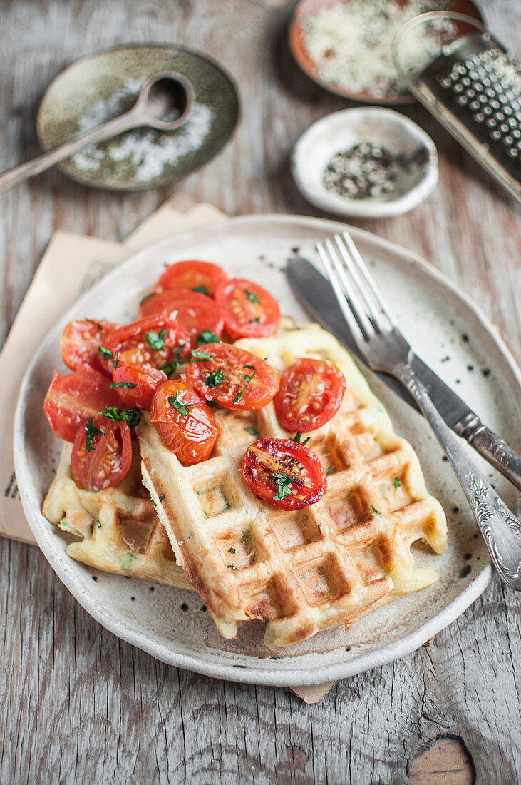 Savory cheese waffles served with roasted cherry toamtoes and chopped fresh parsley