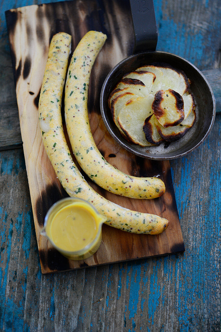 Salmon sausages on a cherry wood plank with Anna potatoes