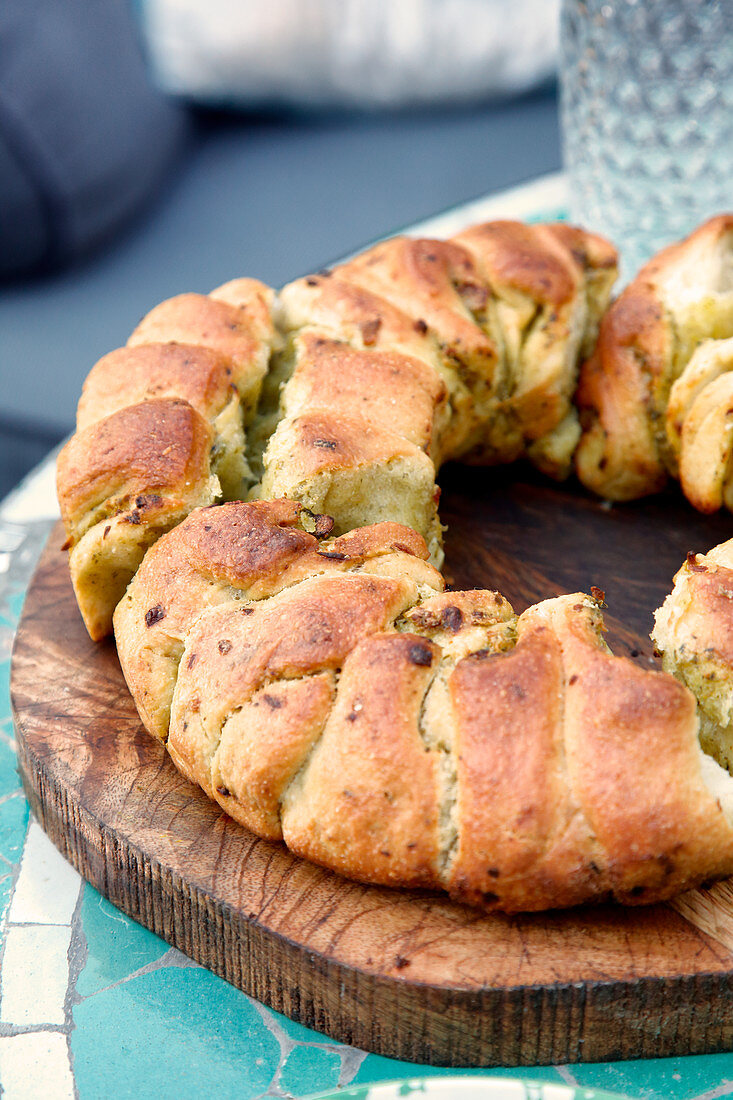 Pull-apart pizza bread on a wooden plate