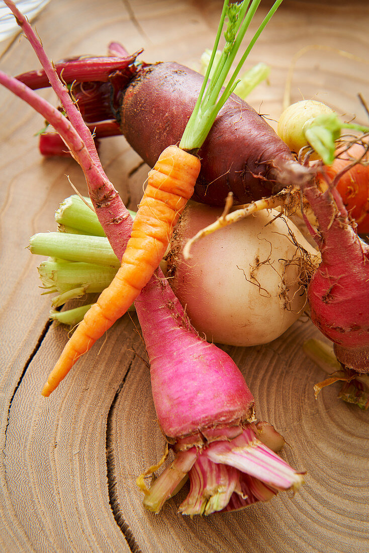 Fresh root vegetables on a wooden board