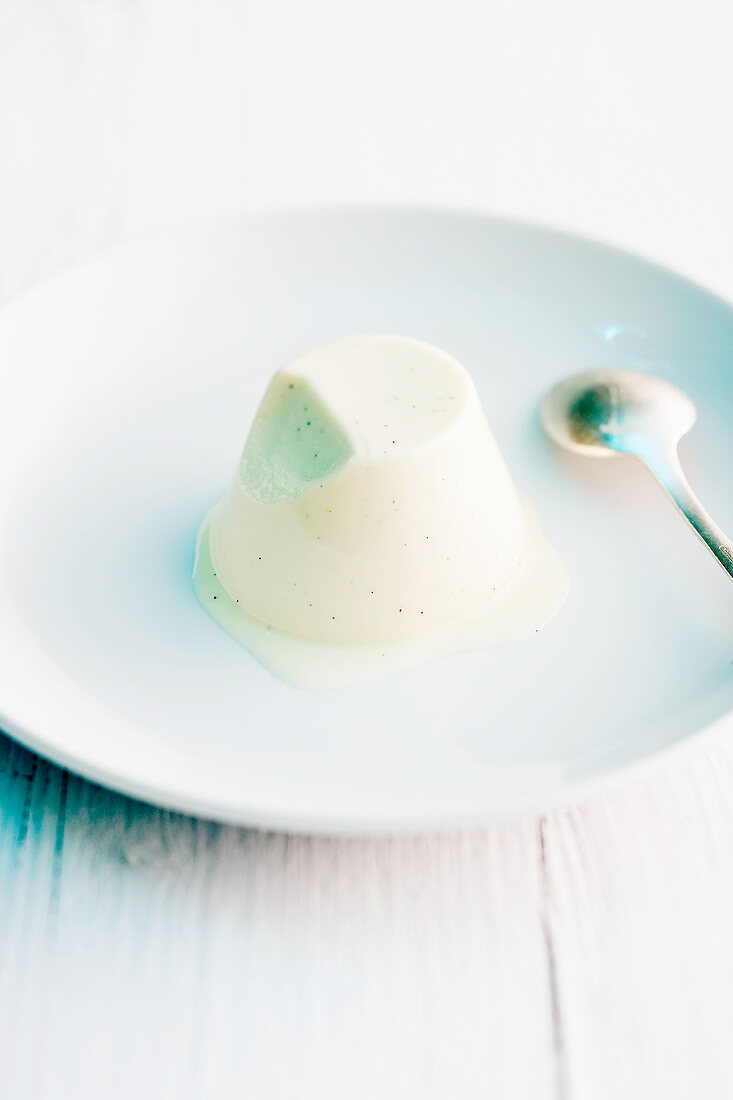 Panna cotta on a plate with a spoon