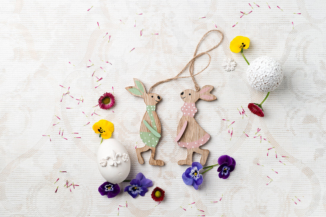 Wooden Easter bunnies with tufted pansies and daisies