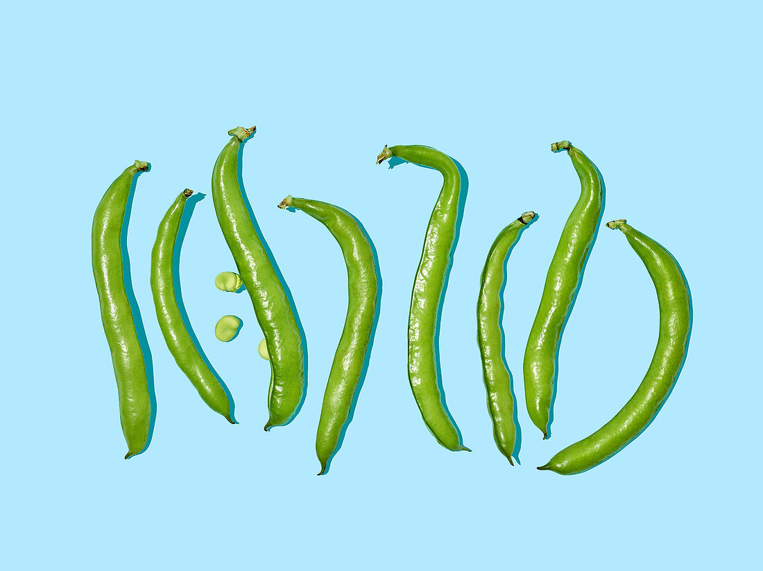 Green beans on a light blue surface