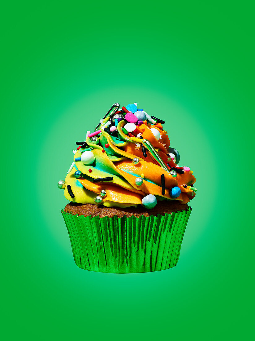 A cupcake against a green background