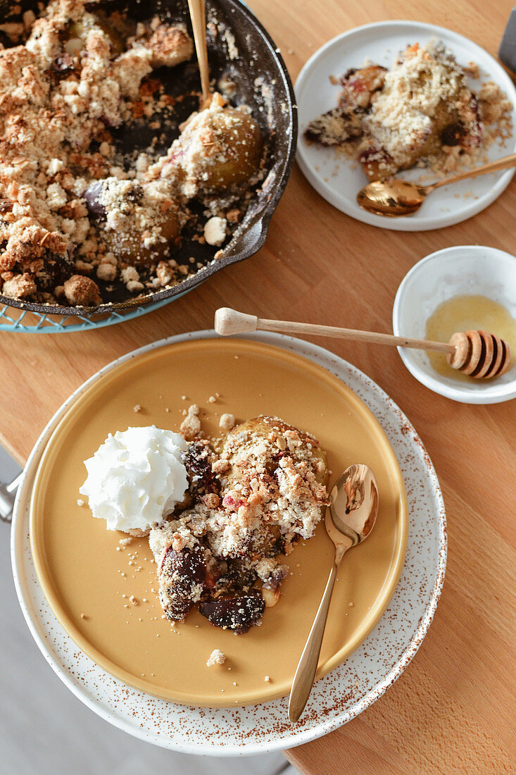 Baked fruit under crumble with whipped cream