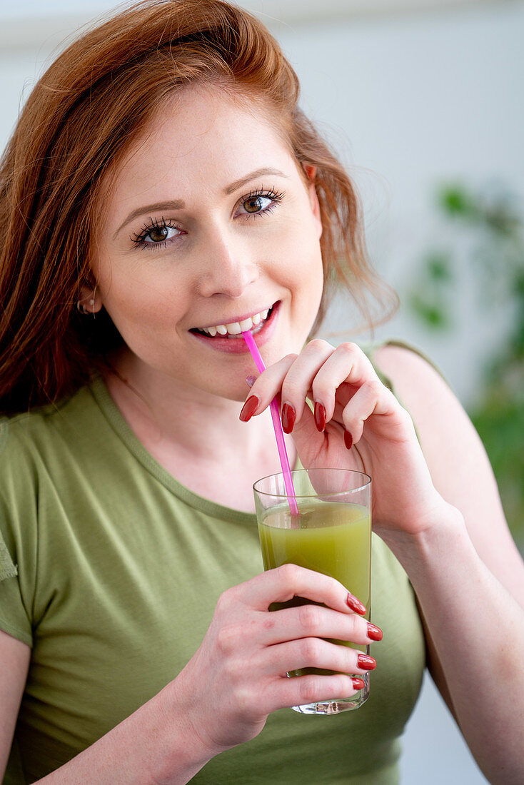 Woman drinking a vegetables juice