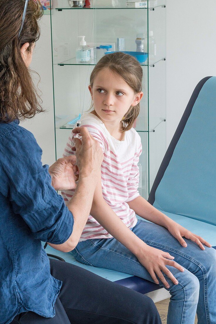 8 year-old girl receiving a vaccination