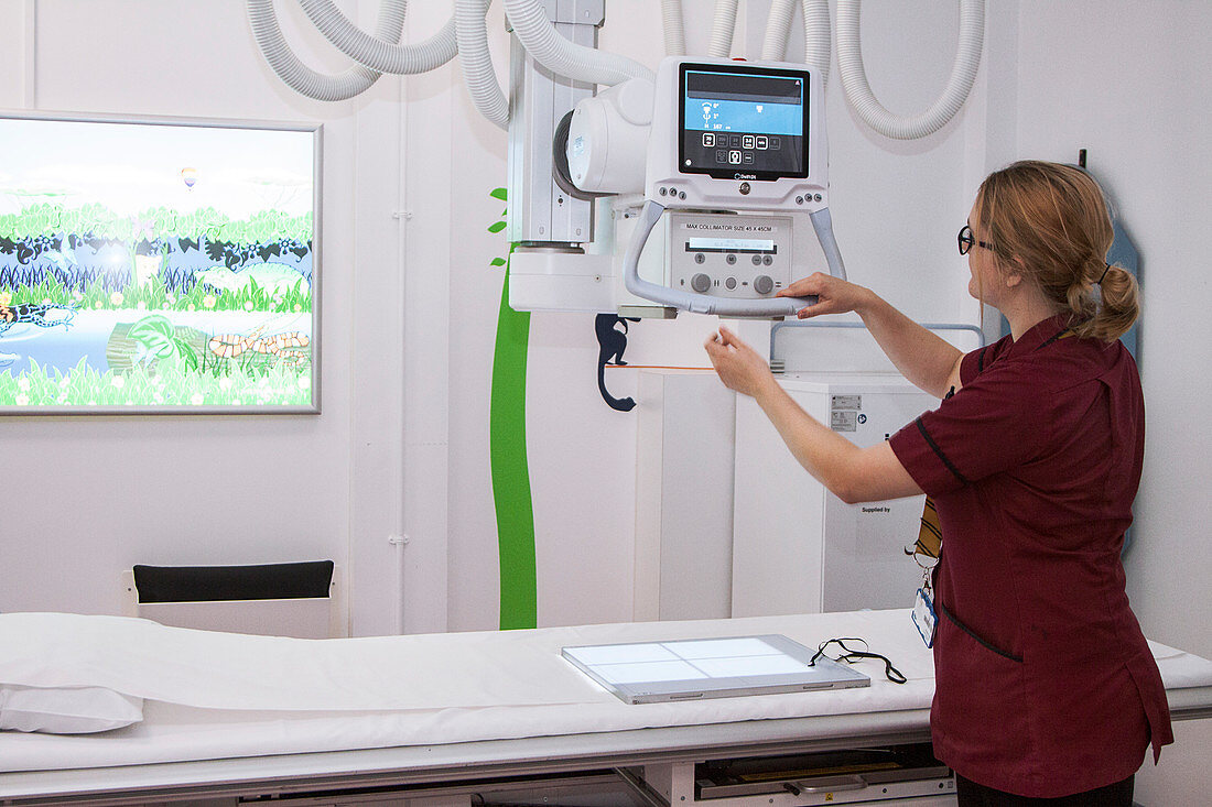 Radiographer preparing an X-ray machine
