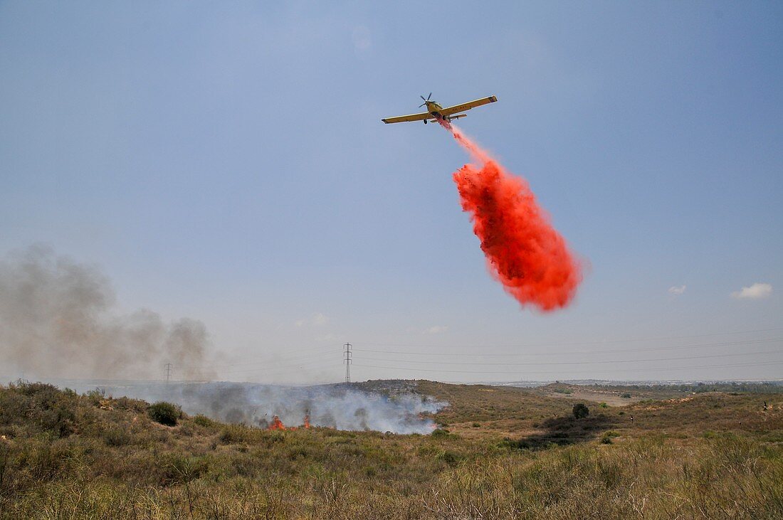 Aircraft dropping fire retardant on a wildfire, Israel