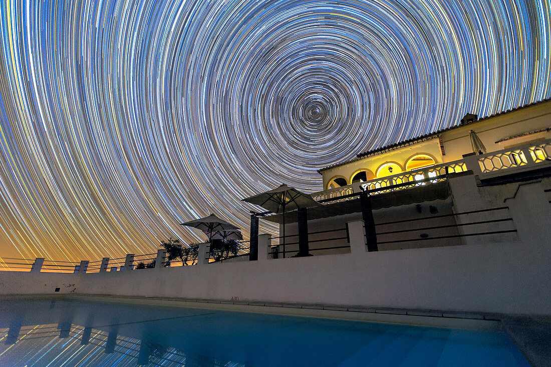 Star trails over Noudar Park building, time-exposure image