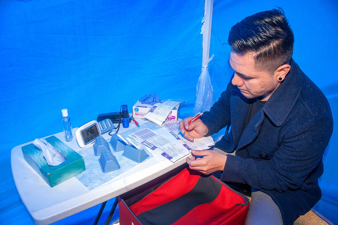 Volunteer prepares HIV test equipment