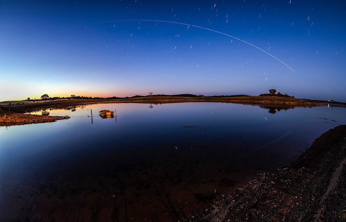 ISS light trail over a lake, time-exposure image