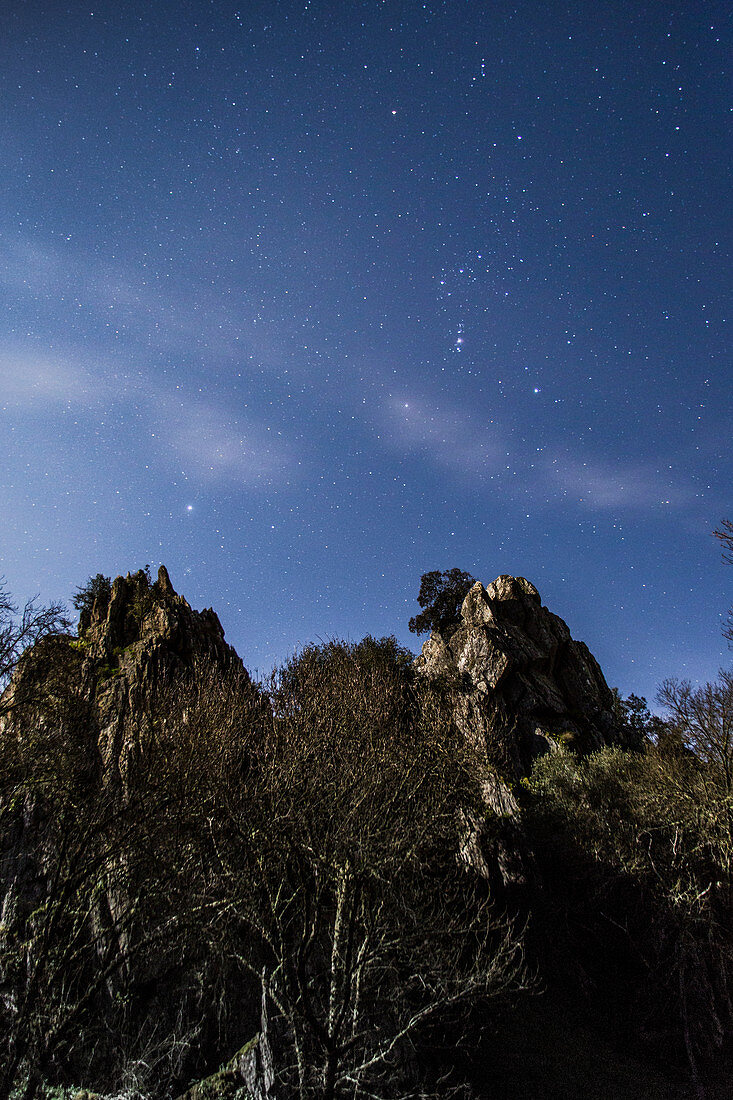 Constellation of Orion over cliff