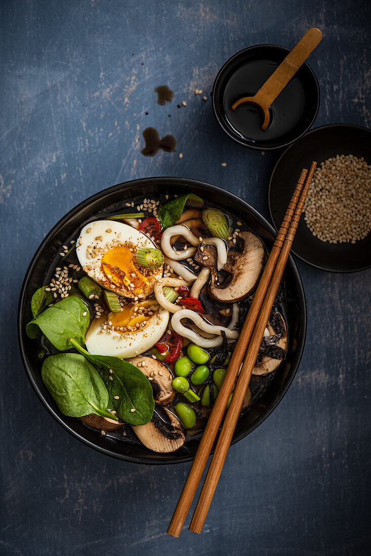 Udon noodle soup with mushrooms, spinach, edame beans, spring onions and boiled egg