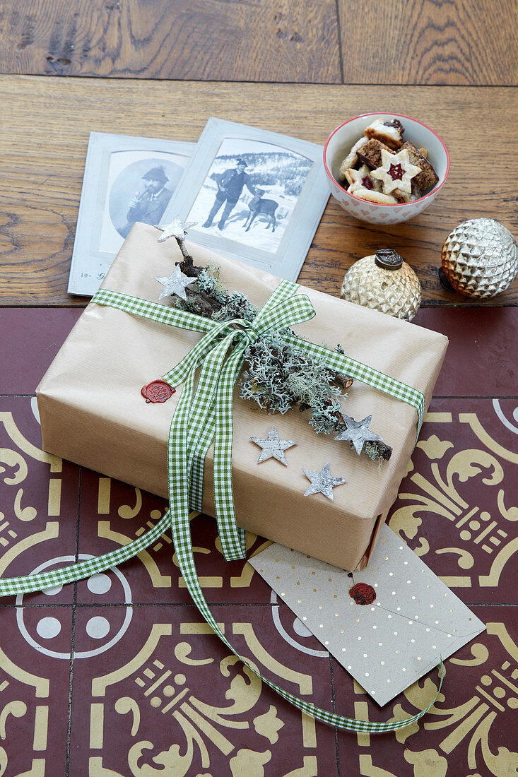 Gift rustically wrapped and decorated with sealing wax and lichen-covered branch
