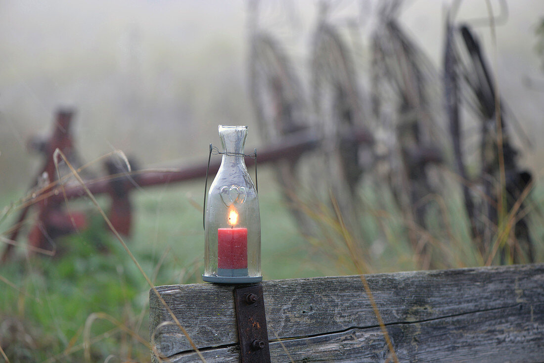 Misty November atmosphere (lit candle in candle lantern)