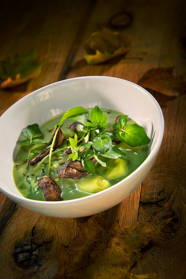 Natural cuisine: potato soup with water cress, spinach and mushrooms
