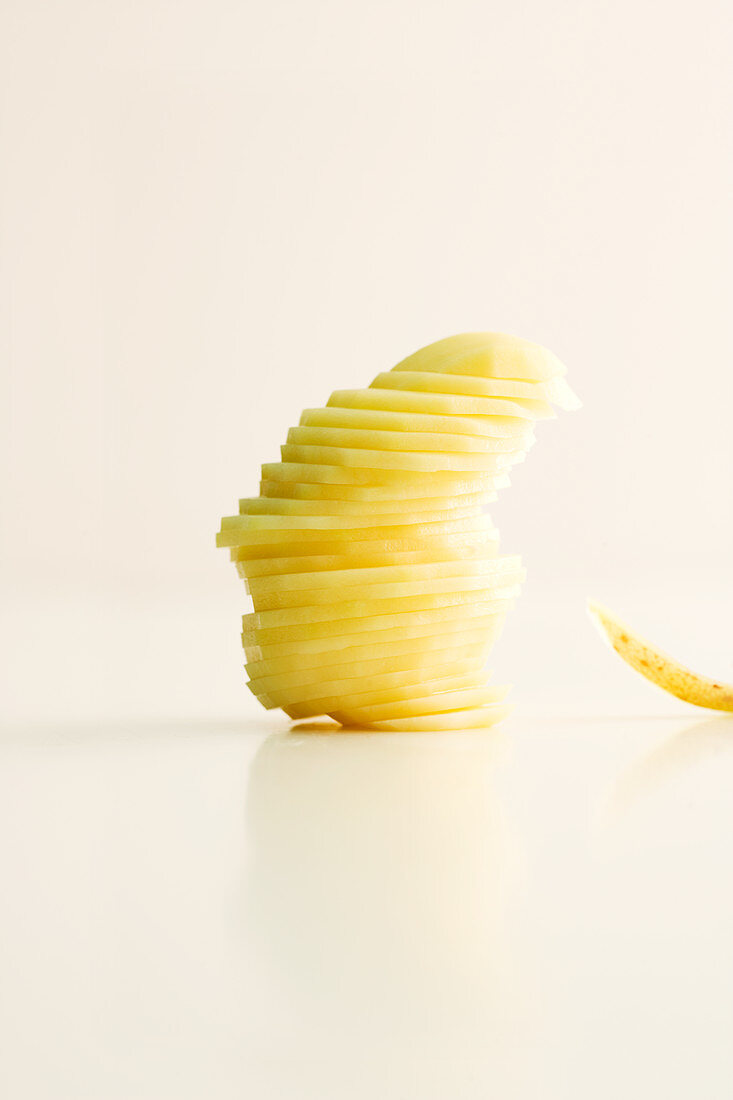 A stack of potato slices for a gratin