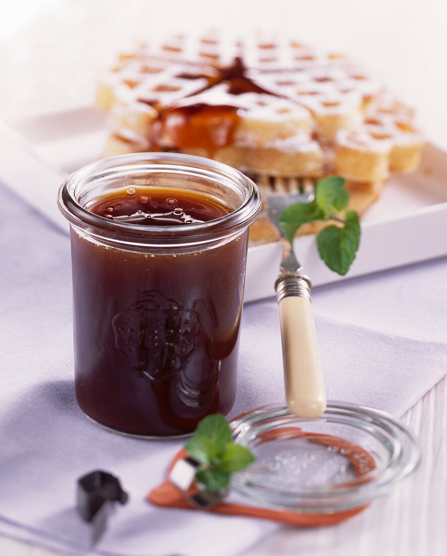 Sea buckthorn in a preserving jar with waffles for breakfast