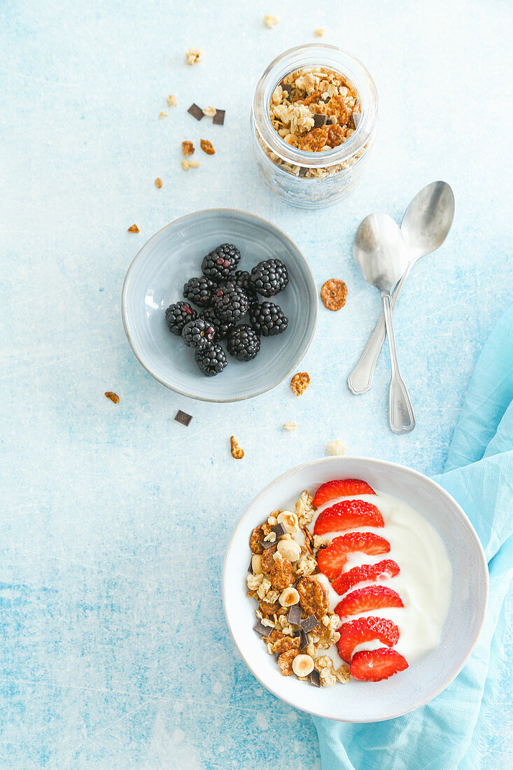 Breakfast with yogurt granola strawberries and blackberries