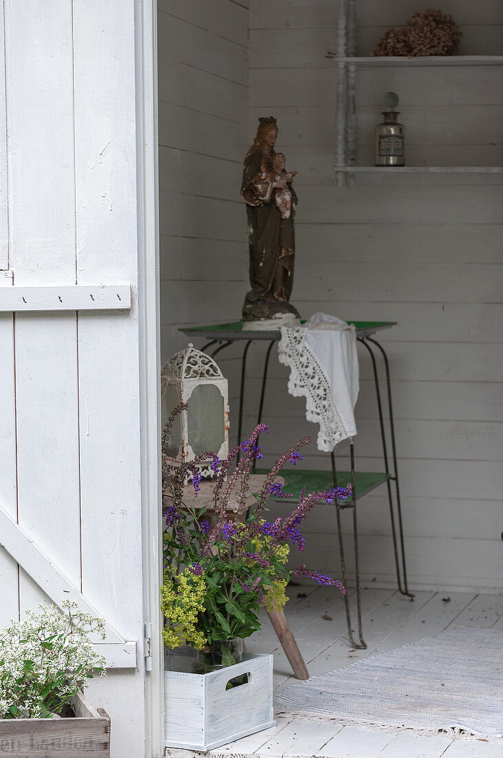 View of Madonna and bouquet of flowers in summerhouse